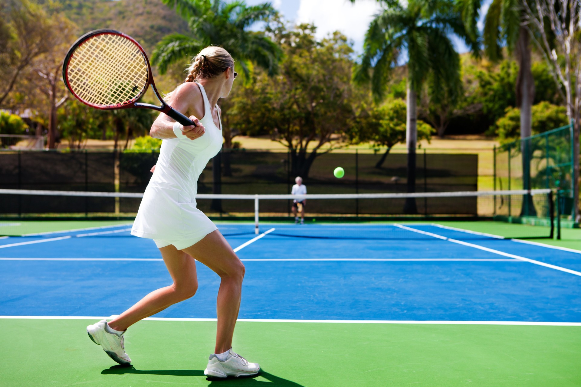 people playing tennis in tropics people playing tennis in tropics